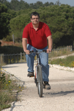 Fat man cycling on the countryside